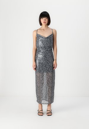 Sheer gray leopard print dress with adjustable straps, fitted bodice, and flowing maxi length, paired with black strappy sandals.