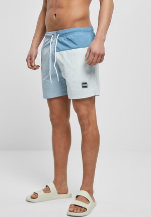 Helle blaue und weiße Badehose mit elastischem Bund und Kordelzug, mit einem Logopatch auf der linken Seite. Glattes, leichtes Material.