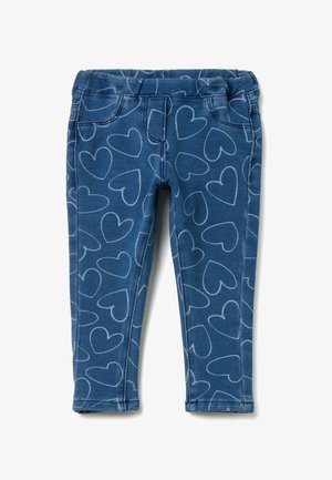 Jeggings azul con una cinturilla elástica, con un patrón de corazones blancos y detalles de costura sutiles. Diseño ajustado con bolsillos frontales.