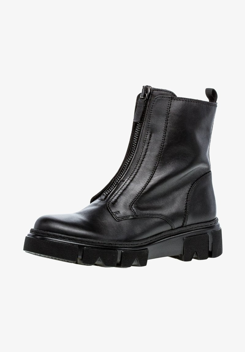 Bottine noire en cuir avec semelle épaisse et fermeture éclair à l'avant, dotée d'une languette à l'arrière pour faciliter l'enfilage.