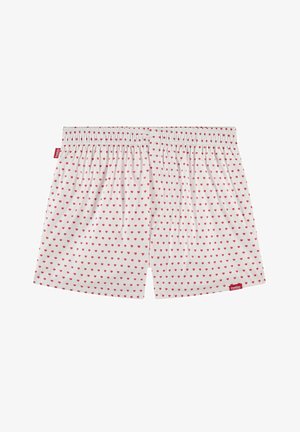 Boxeurs blancs avec de petits motifs de cœurs rouges, taille élastique et une étiquette de marque sur le côté gauche. Matière en coton, coupe décontractée.