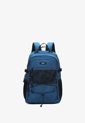 Blue backpack with padded shoulder straps, front mesh pocket with elastic cords, side mesh pockets, and a top handle.