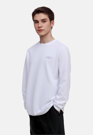 Witte sweatshirt met lange mouwen, ronde hals, rekbare katoenmix, lichte textuur, heeft een klein blauw tekstlogo op de borst, ontspannen pasvorm.