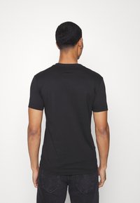 Calvin Klein Jeans REPEAT LOGO TEE UNISEX - T-shirt estampada - black