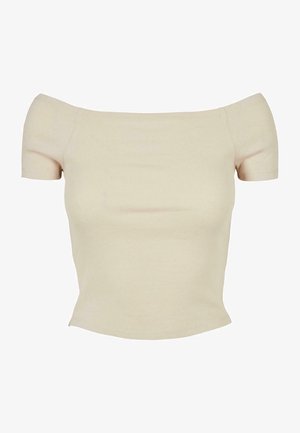 Vállnélküli, rövid ujjú, bordázott felső világos bézs színben. Feszes sziluett és puha tapintás jellemzi, zökkenőmentes kidolgozással.