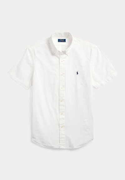 Short-sleeve white button-up shirt made of lightweight fabric. Features a pointed collar and small embroidered logo on the chest.