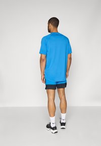 Under Armour VANISH GRAPHIC SHORT - Pantaloni scurți sport - blue atlantis/black