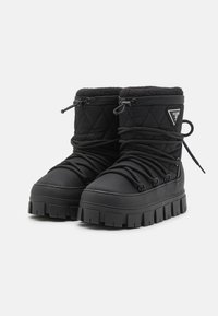 Zwarte, gewatteerde enkellaarsjes met een dikke rubberen zool, vetersluiting en fleece voering. Kenmerkt een driehoekig logo-accent aan de zijkant.