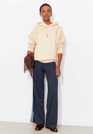 MOTIF TUFTING - Sweat à capuche - imprimé écru