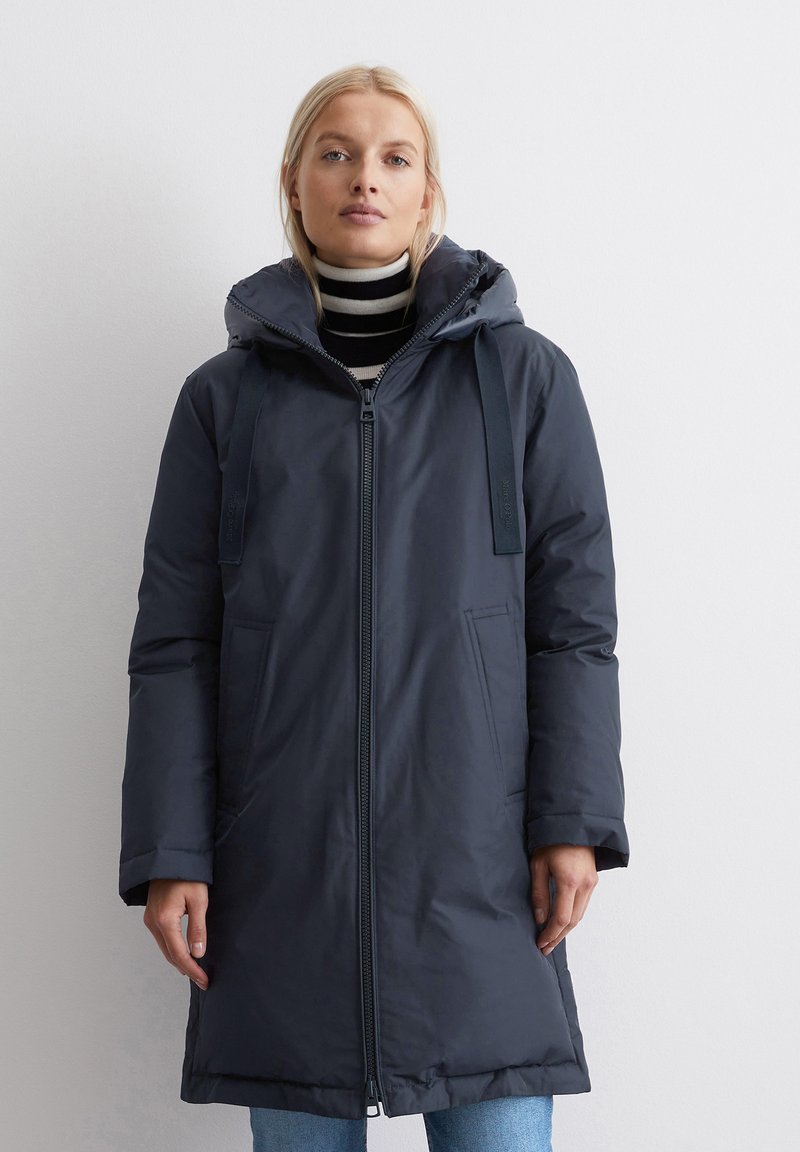 Long navy padded coat with a zip front, adjustable drawstring hood, and two front pockets. Features a smooth, shiny texture.