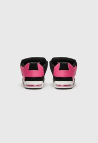 Black and pink sneakers with a smooth synthetic upper, rounded shape, distinct heel accents, and clear air cushioning in the sole.