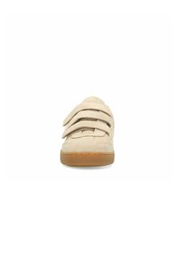 Beige klittenbandsneaker met een zachte suède textuur, voorzien van drie banden over de bovenkant en een bruine rubberen zool.