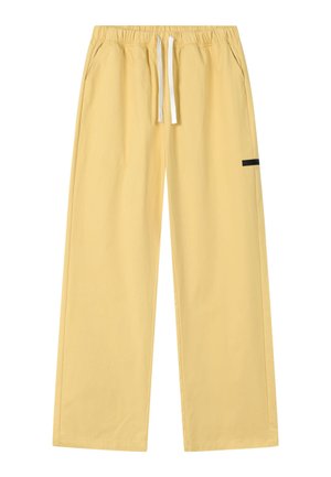 Gelbe Hosen mit weitem Bein, elastischem Bund, weißem Kordelzug, Seitentaschen und einem kleinen schwarzen Etikett am rechten Bein.