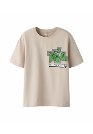 Beżowa koszulka z krótkim rękawem z motywem Minecraft, przedstawiająca trzy zielone pikselowane postacie Creeper nad logo Minecraft na piersi.