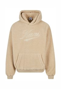 Beige plüss kapucnis pulóver texturált felülettel, kapucnival és elülső zsebbel. A logó hímzett, világosabb árnyalatban.