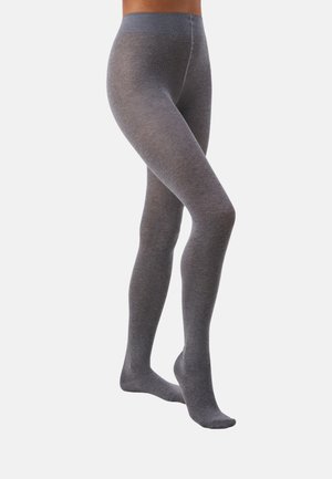 Mallas opacas grises con una textura suave, cinturilla alta y un ajuste que alisa. Presentan un diseño sin costuras que se extiende desde la cintura hasta el tobillo.