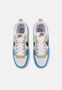 White sneakers with blue, beige, and navy accents. Features include perforated toes, white laces, and a prominent Nike logo.