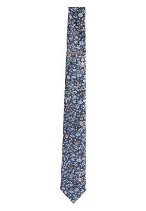 Navy blue necktie with light blue and beige floral pattern, slim design, and a matching fabric loop near the top.
