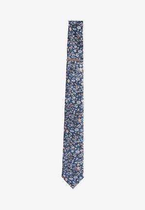 Navy blue necktie with light blue and beige floral pattern, slim design, and a matching fabric loop near the top.