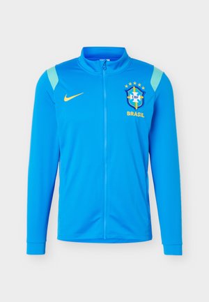 Modrá sportovní bunda na zip s logem brazilského fotbalového týmu, žlutým znakem Nike a světle modrými akcenty na ramenou.