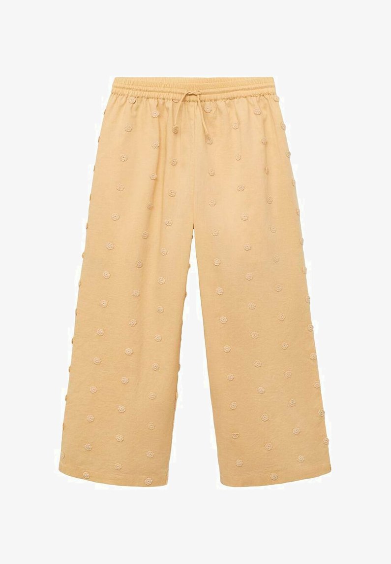 Yellow cotton cropped pants with an elastic waistband, featuring textured floral embroidery in a repetitive pattern across the fabric.