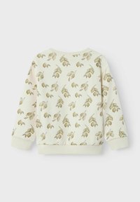 Sudadera de crema clara con patrón de hojas verdes. Presenta cuello redondo, mangas largas y puños acanalados. Textura suave, diseño casual y parte trasera sin adornos.