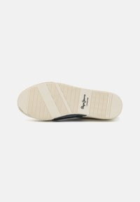 White rubber sole with textured grooves and a black accent. Features a branding stamp on the side for identification.