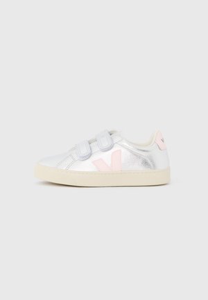 Silver metallic sneakers with Velcro straps, pink accents, and light beige soles. Rounded toe and smooth texture.