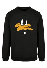 Felpa nera in cotone con polsini e orlo a coste. Presenta una grafica del volto di un'anatra in cartoon nei colori arancione, bianco e nero.