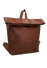 Brown leather backpack with a fold-over flap, top handle, adjustable straps, and side accents. Smooth texture with visible stitching.
