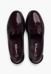 Burgundy leather loafers with a smooth finish, decorative stitching, and perforated insole. Rounded toe and slip-on design for ease of wear.