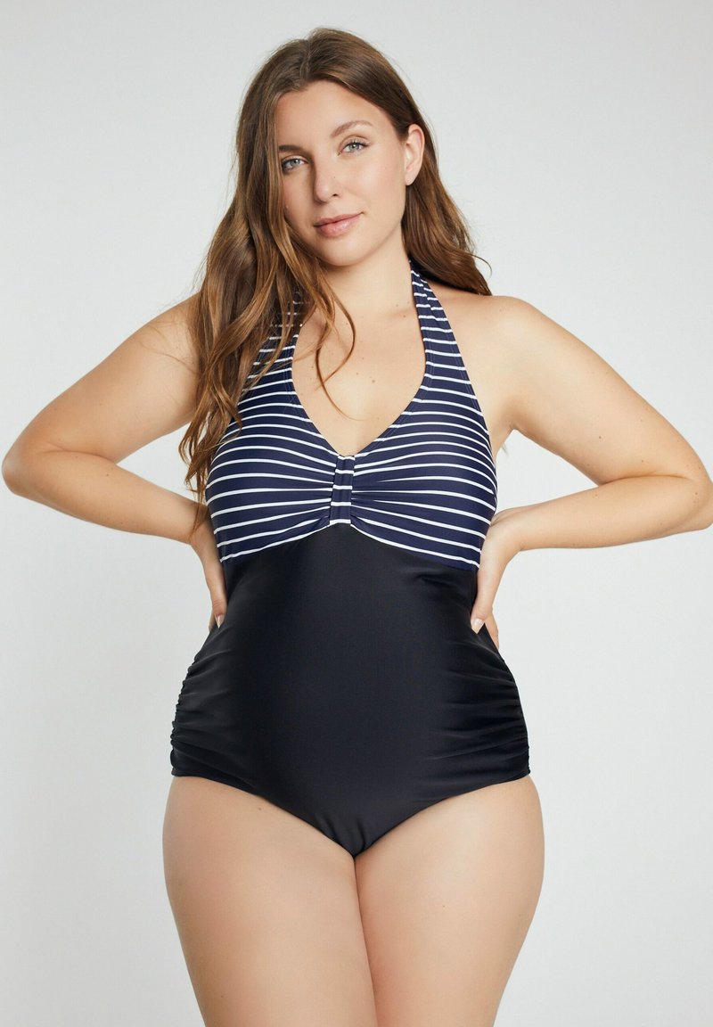 Laivastonsininen ja valkoinen raidallinen uimapuku, jossa on kaula-aukko, ja jossa on kerätty musta alaosa sekä keski-informaatio etupuolella. Sujuvan kankaan pinta.