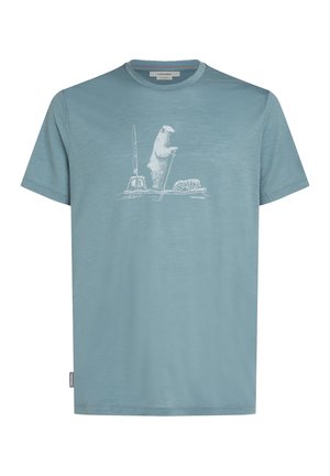 Light blue cotton t-shirt featuring a polar bear graphic with a paddle and a wheel. Short sleeves and a crew neckline. Subtle texture.