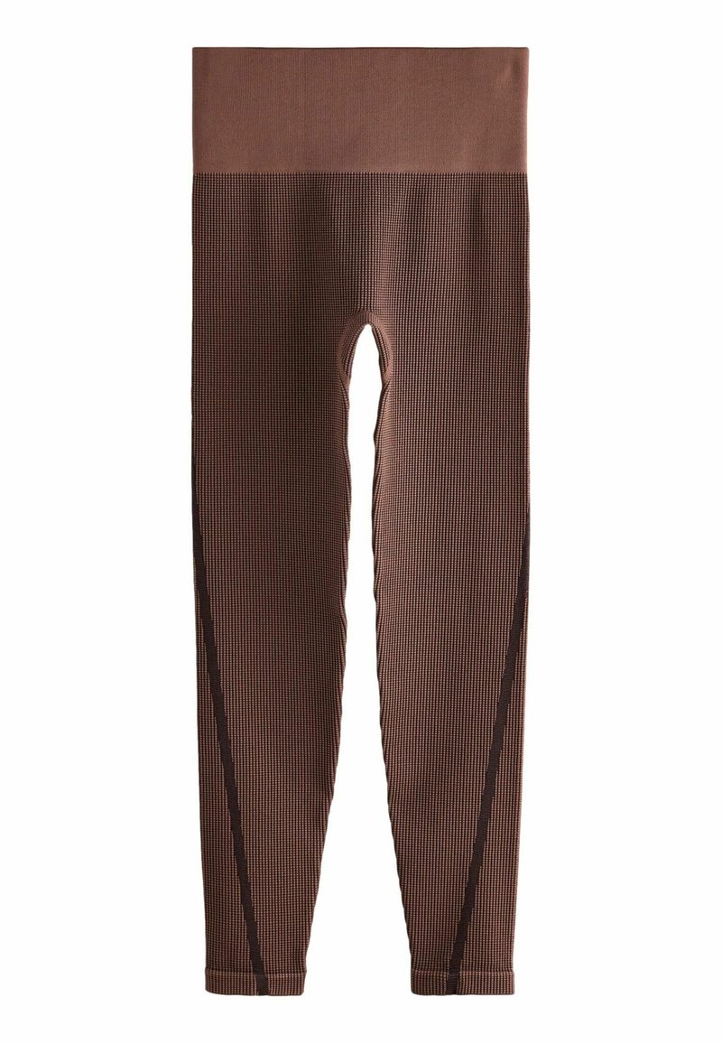 Bruine geribde leggings met een hoge taille en zijuitsparingen. Heeft een textuurstof en contrasterende donkere naden langs de zijkanten.