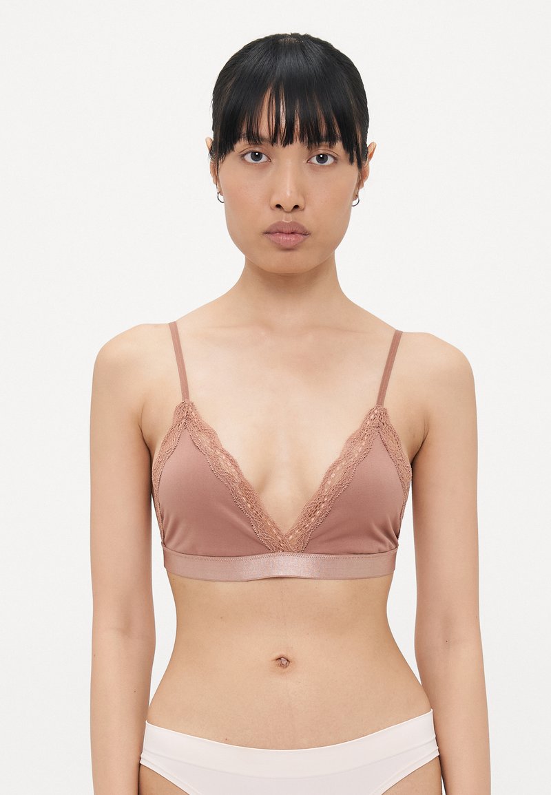 Bra in soft brown fabric with lace trim, featuring a deep V-neck, adjustable straps, and a smooth band.