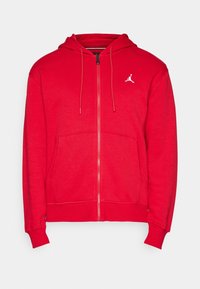 Rode hoodie met ritssluiting, met trekkoorden, voorzakken en een klein wit Jumpman-logo op de linkerkant van de borst.