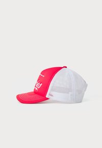 Red and white baseball cap with a curved visor, mesh back, and embroidered front text. Features stitching details on the visor.