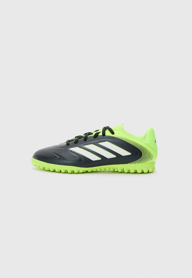 Voetbalschoenen met een zwarte bovenkant, neon groene accenten, drie witte strepen, een gestructureerd oppervlak en een rubberen zool met kleine noppen.