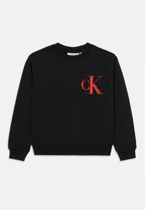 Black sweatshirt in soft material with long sleeves, rounded neck, and a red "CK" logo on the left chest in distressed style.
