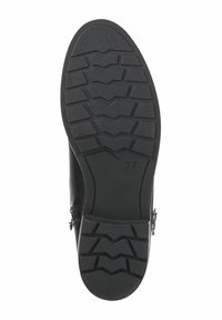 Semelle de botte en cuir noir présentant un motif texturé en zigzag pour une meilleure traction. Taille marquée comme 37 ; comprend un détail de fermeture éclair sur le côté.