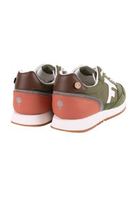 Green and brown sneakers featuring a white logo, leather and suede materials, round accents, and a textured brown sole.