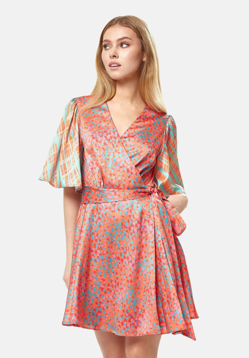 Wrap dress in orange with blue and pink abstract patterns. Features short flared sleeves and a tie waist for adjustable fit. Smooth texture.