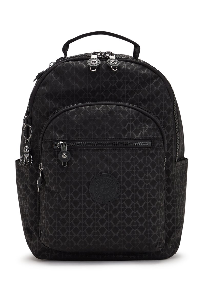 Black fabric backpack with geometric pattern, zippered main compartment, front pocket, and a top handle. Features silver hardware accents.