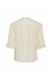 Blusa color crema hecha de tela ligera, con mangas abullonadas, rayas verticales y sutiles puntos multicolores en toda la superficie.