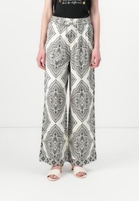Pantaloni a gamba larga con un motivo paisley in bianco e nero, vita elasticizzata con stringa di regolazione e un tessuto liscio e leggero.