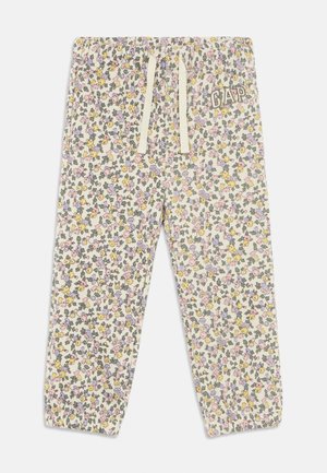 Pantaloni della tuta a fantasia floreale in crema con fiori multicolori. Presentano una vita elasticizzata con coulisse e polsini a coste, logo del brand sul lato.