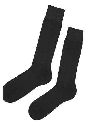 Schwarze knielange Socken aus einem glatten, dehnbaren Material mit einem gerippten Bündchen und nahtloser Verarbeitung für eine bequeme Passform.
