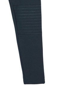 Mørkeblå strækstof leggings med et tekstureret panel på låret, der har vandrette syninger og en tætsiddende pasform.