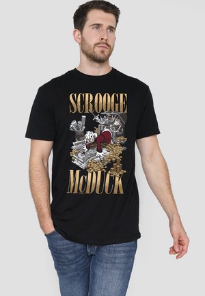 Black cotton t-shirt featuring a graphic of Scrooge McDuck surrounded by gold coins, with gold text reading “SCROOGE McDUCK.” Classic fit.