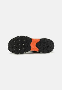 Semelle en caoutchouc noir pour chaussures de sport, avec un motif texturé et durable, et un accent intermédiaire orange. Conçue pour l'adhérence et la traction.